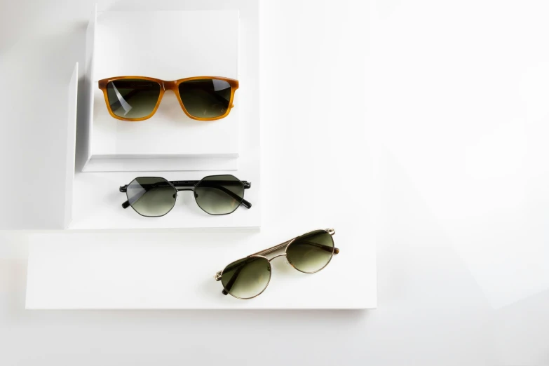 an empty white box holds sunglasses in which two are reflected in them