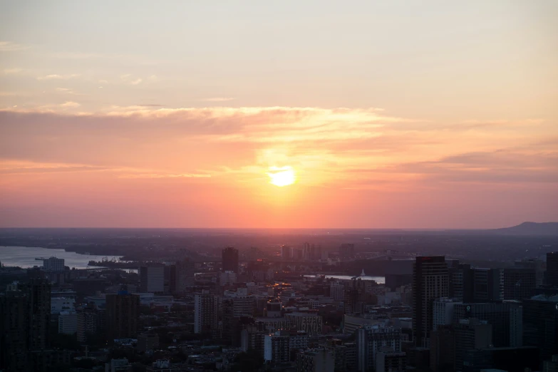 a view of the sun going down behind the city skyline