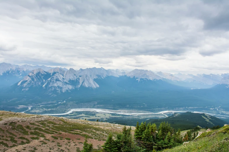 a view from the top of a mountain that has mountains and valleys behind it