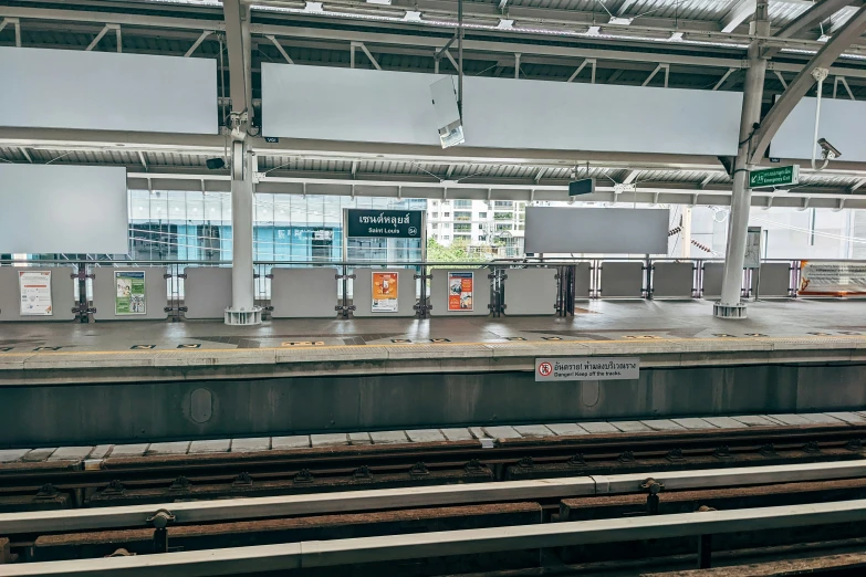 a train station with many train carts on the track