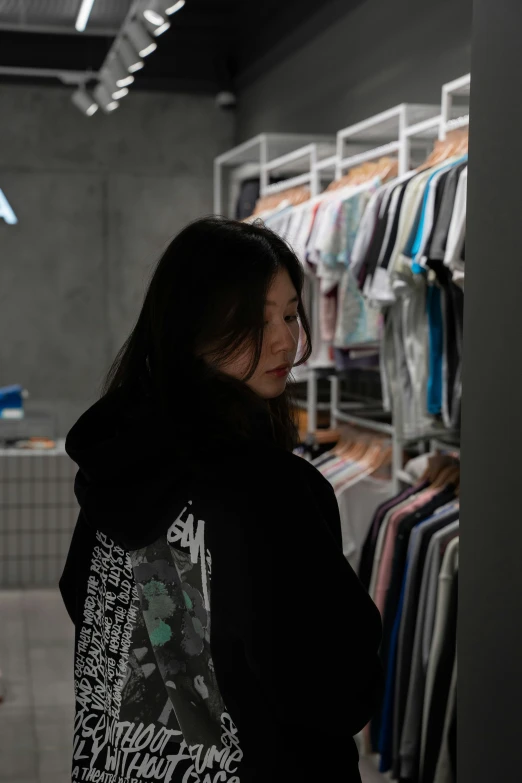 woman looks at her phone in a retail store