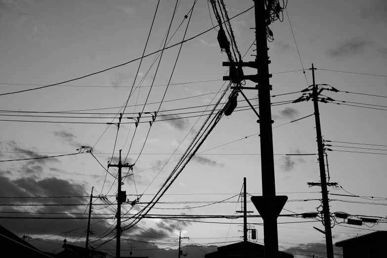 an electric pole with wires in the sky and one telephone