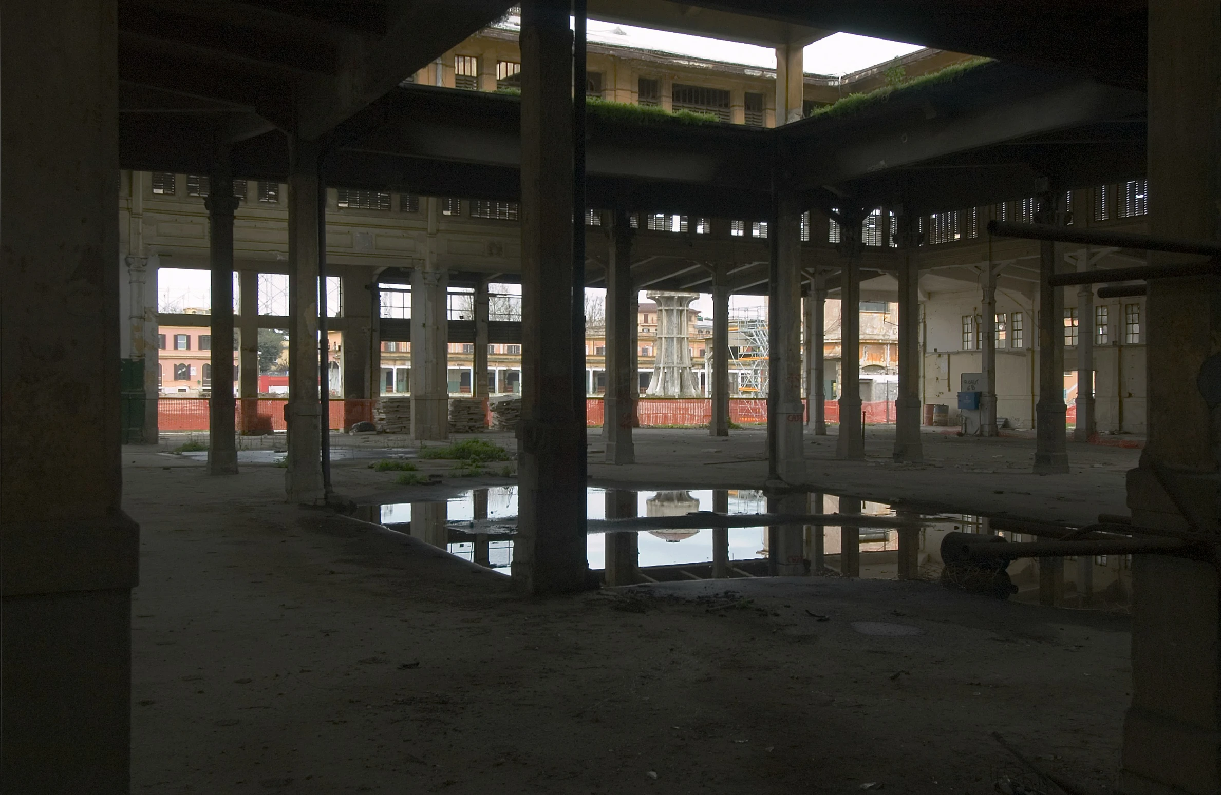 empty parking garage with lots of windows reflected in the pool