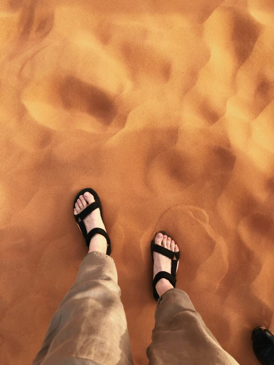 someone is wearing sand sandals in the desert