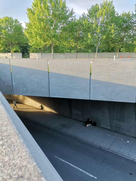 a street below an overpass that is blocked off by guardrails