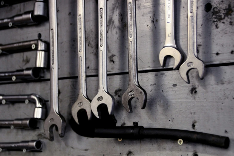 a number of wrenches hanging on a wall