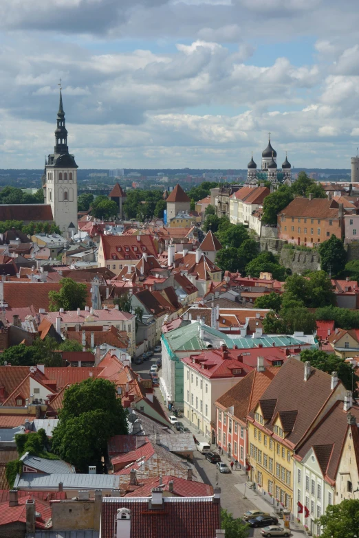 a city with several buildings and trees in the middle