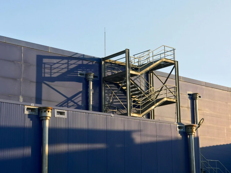 the side of an industrial building with stairs