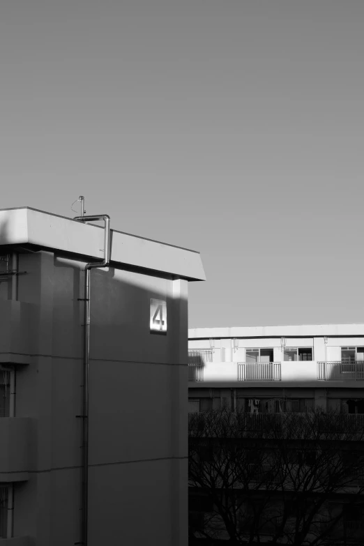 black and white pograph of a building in front of a city