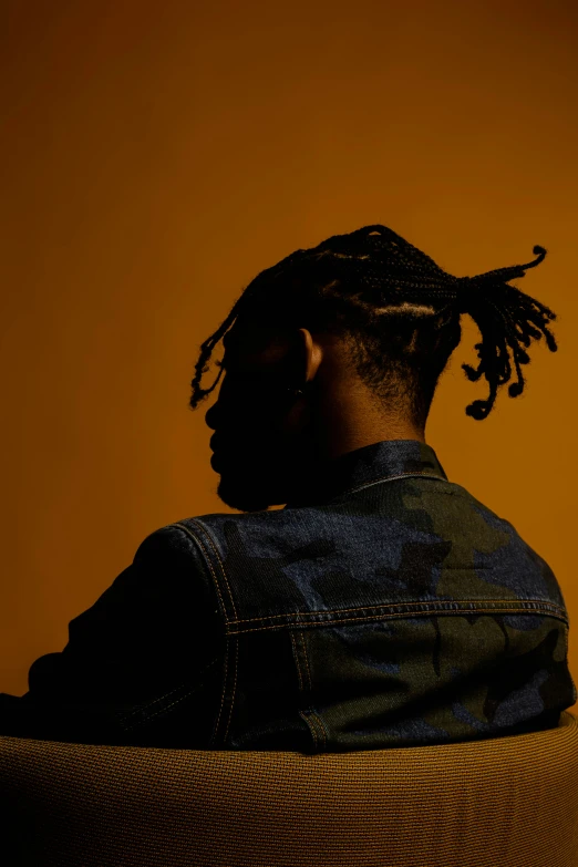 a silhouette picture of a man with dreadlocks