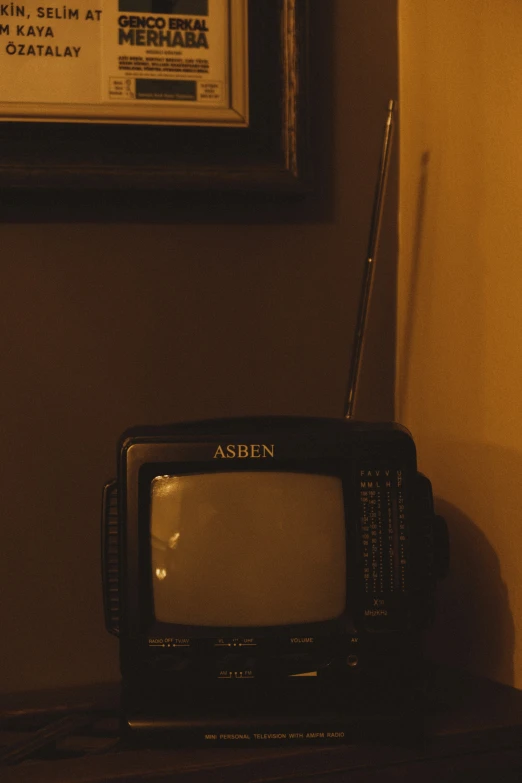 an old fashioned tv is set up next to a frame