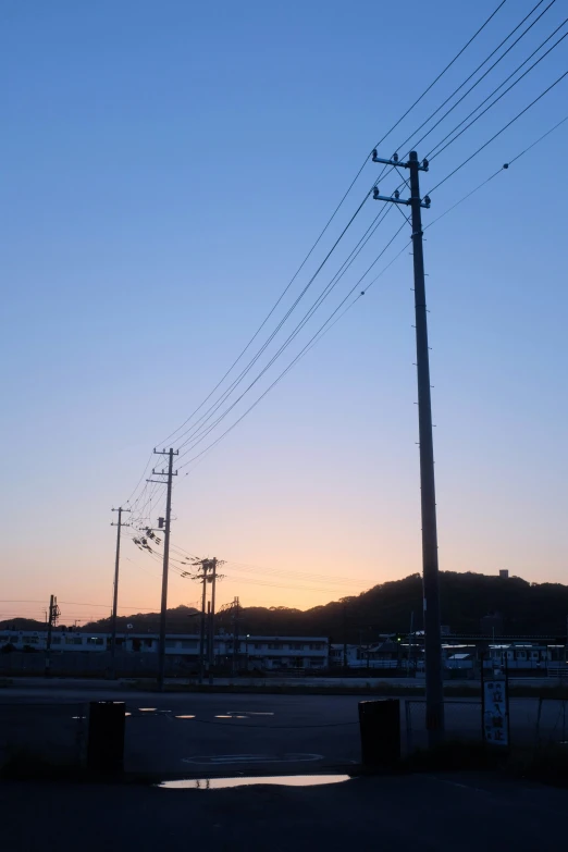 the electric poles are near the street intersection