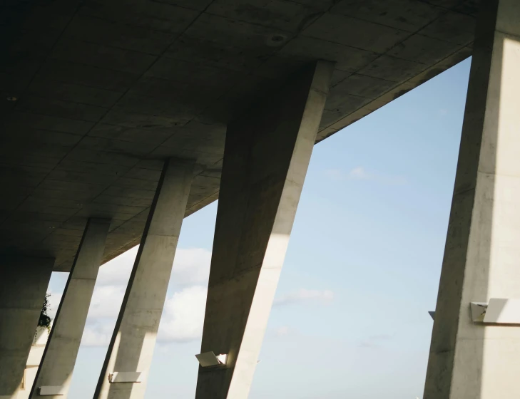 a couple of tall cement columns on the side of a road