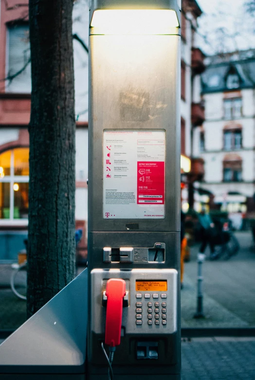 an electronic machine sitting next to a tree