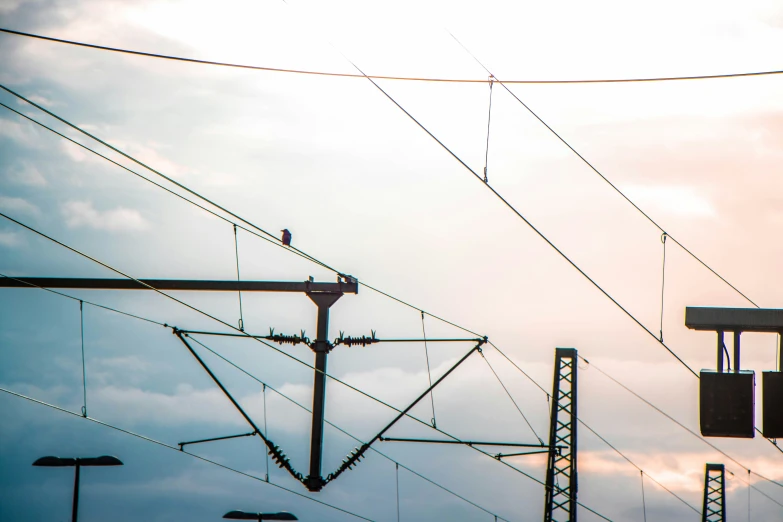 power lines and street signs against a stormy sky