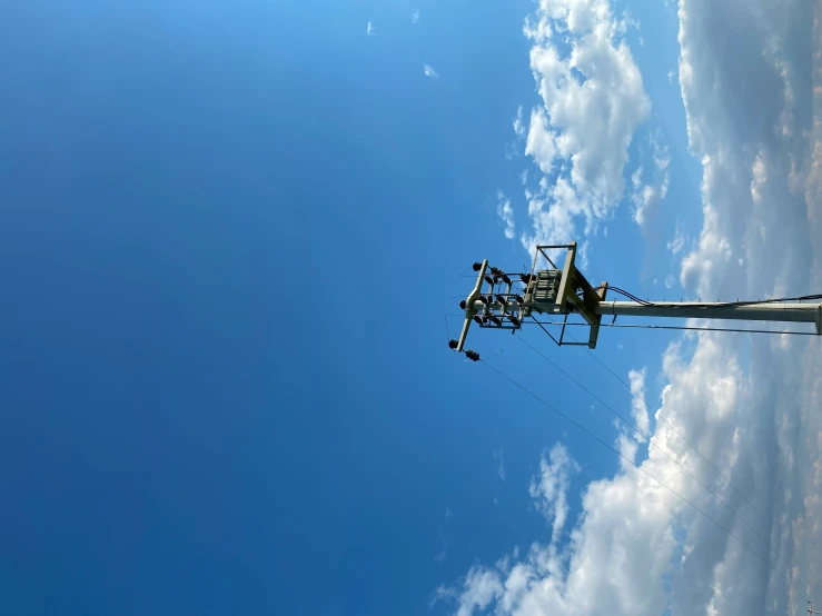 a telephone pole and some clouds in the sky