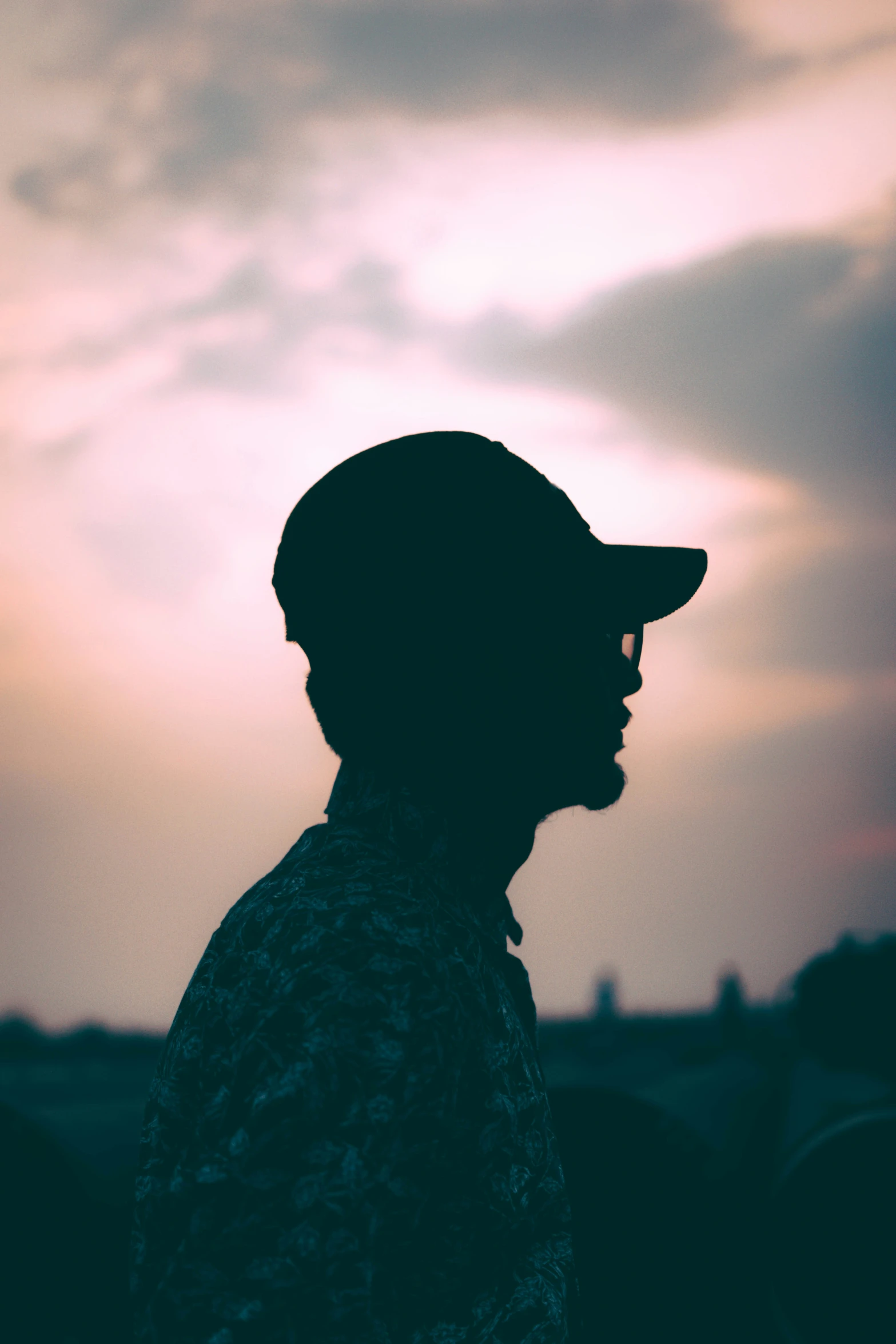 a man who is wearing a hat looking at the sky