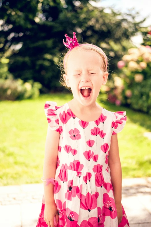 a little girl laughing and sticking out her tongue