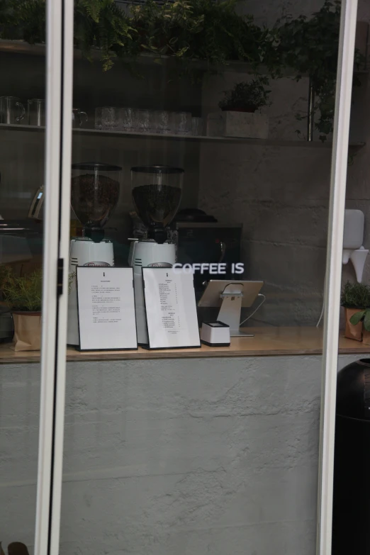 several menus displayed behind glass in front of a window