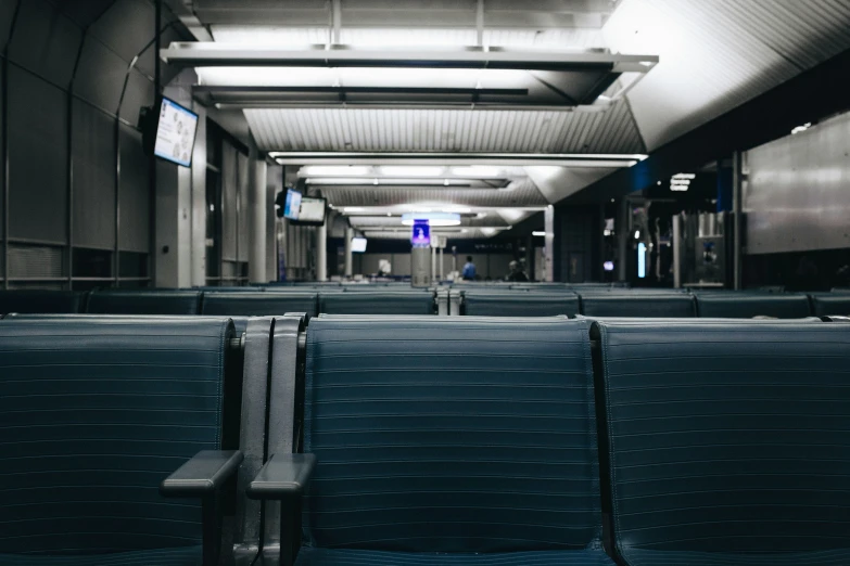 empty chairs in a dimly lit subway or bus station