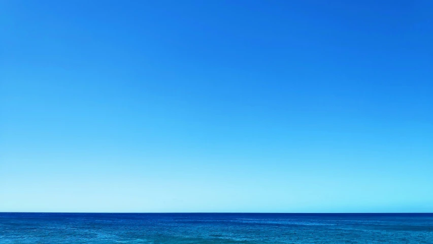 a sail boat is in the ocean with a sky background