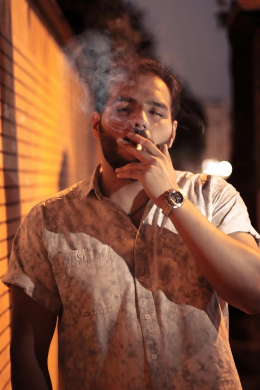 a young man smoking a cigarette, with a blurred background