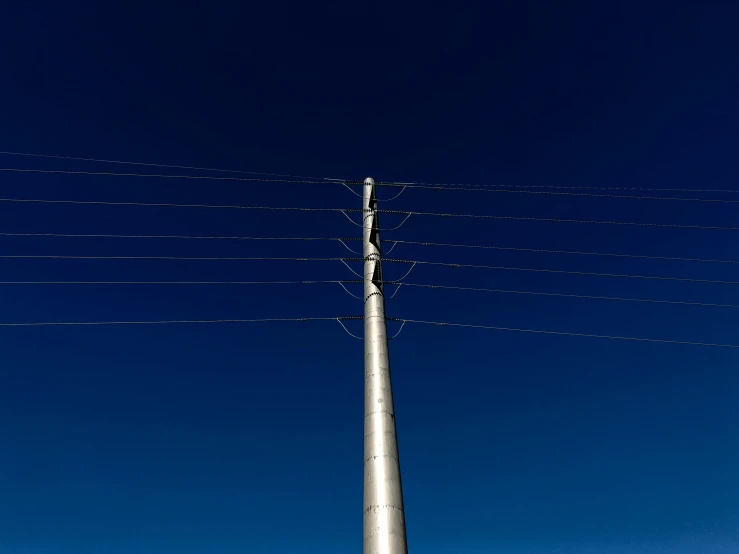 an electronic tower against a blue sky in a city
