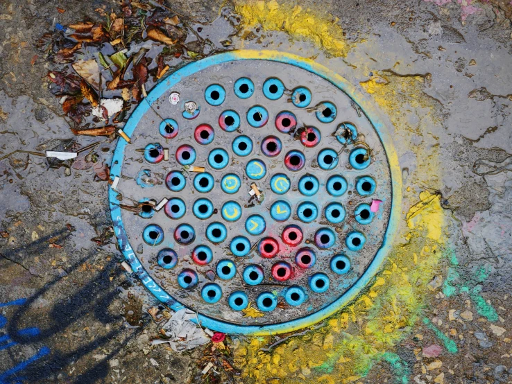 a dirty floor drain with circles of different colors