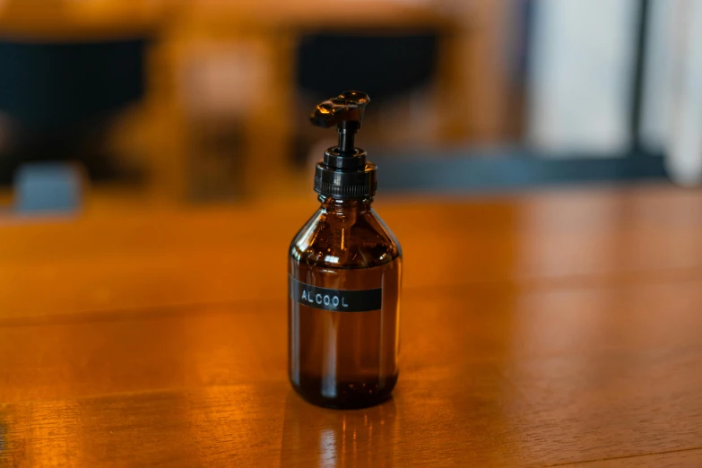 a brown glass bottle with a liquid pump on it