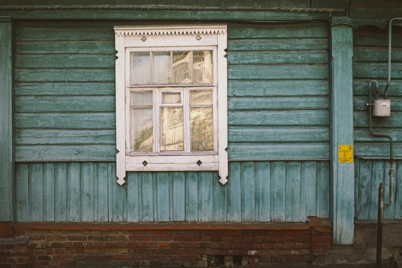 old windows in front of a blue house