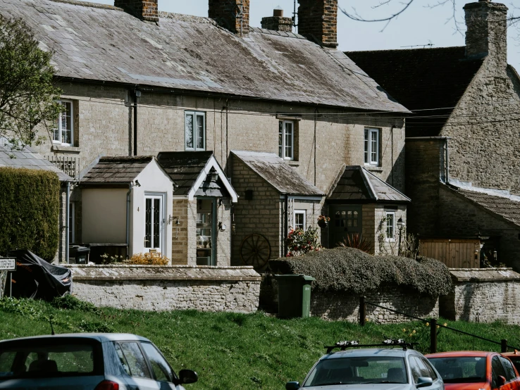 three cars parked in front of a house and some trees