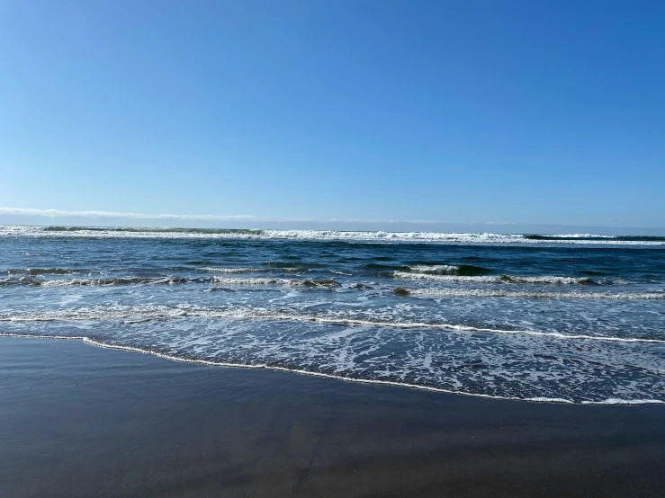 a close up of waves on the beach