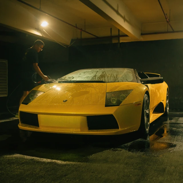 a yellow lamborgan parked in a parking lot