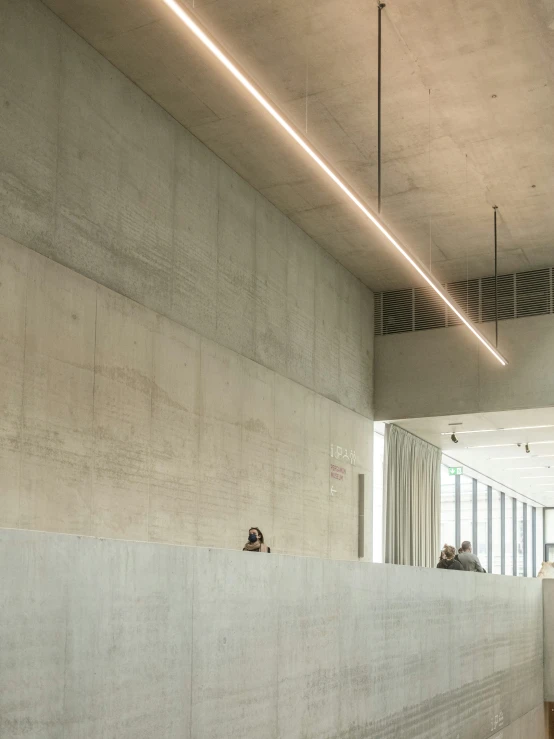 a building with some windows and a person sitting in a lobby