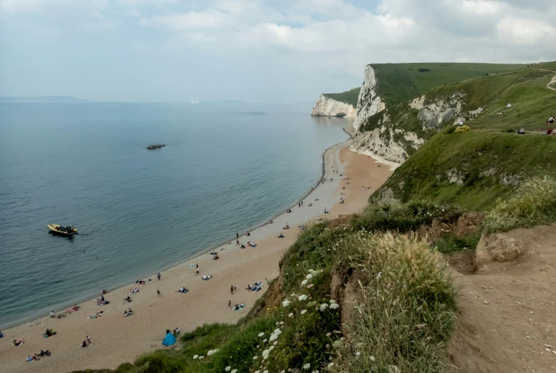 there are people on the sand and the water