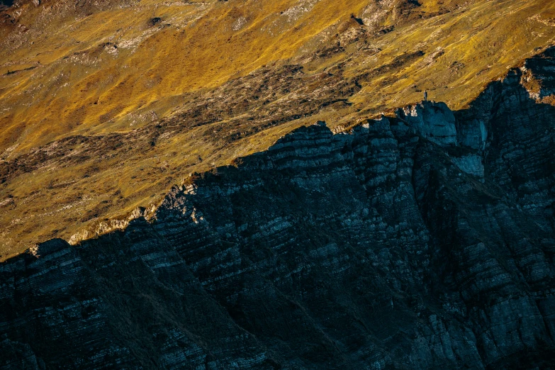 an aerial po of mountains with yellow tops and brown grass