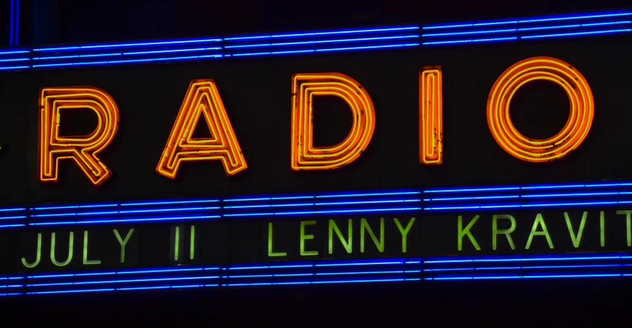 a radio sign with a neon light above it