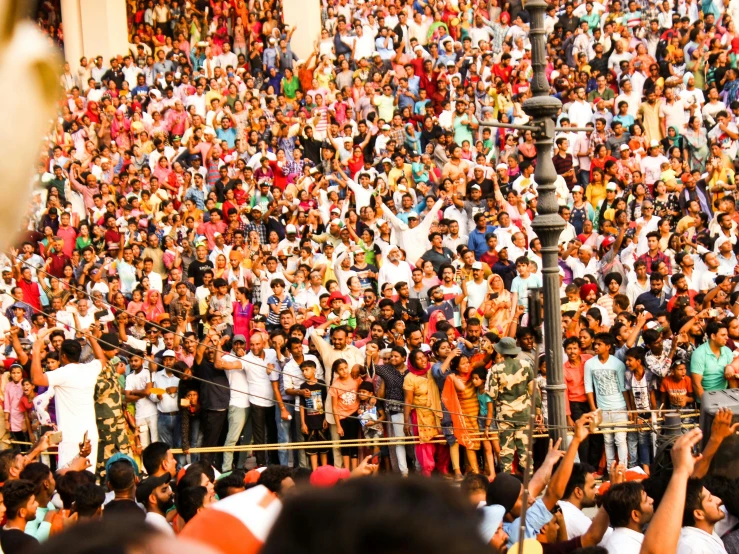 the crowd is standing in front of the street light