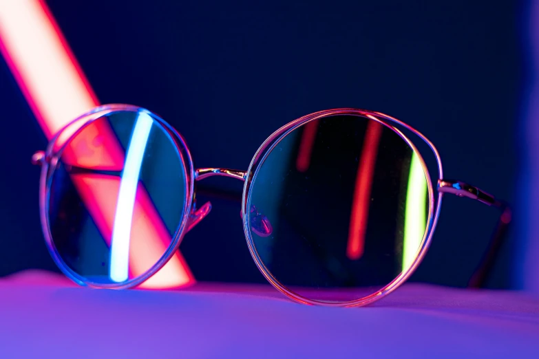 a pair of sunglasses sitting on top of a blue table