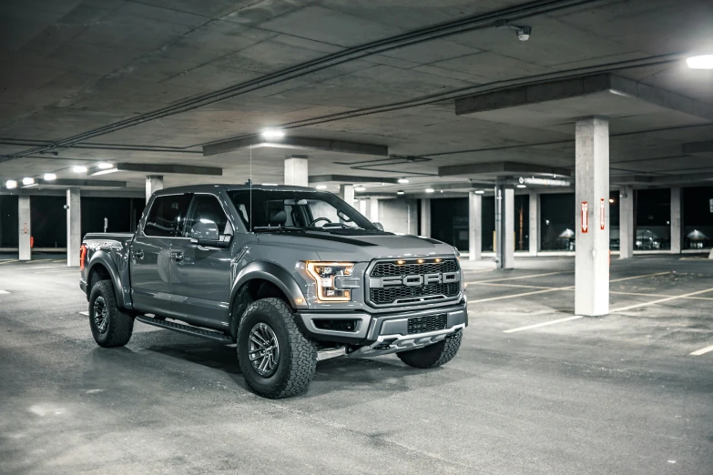 a gray ford truck parked in a parking garage