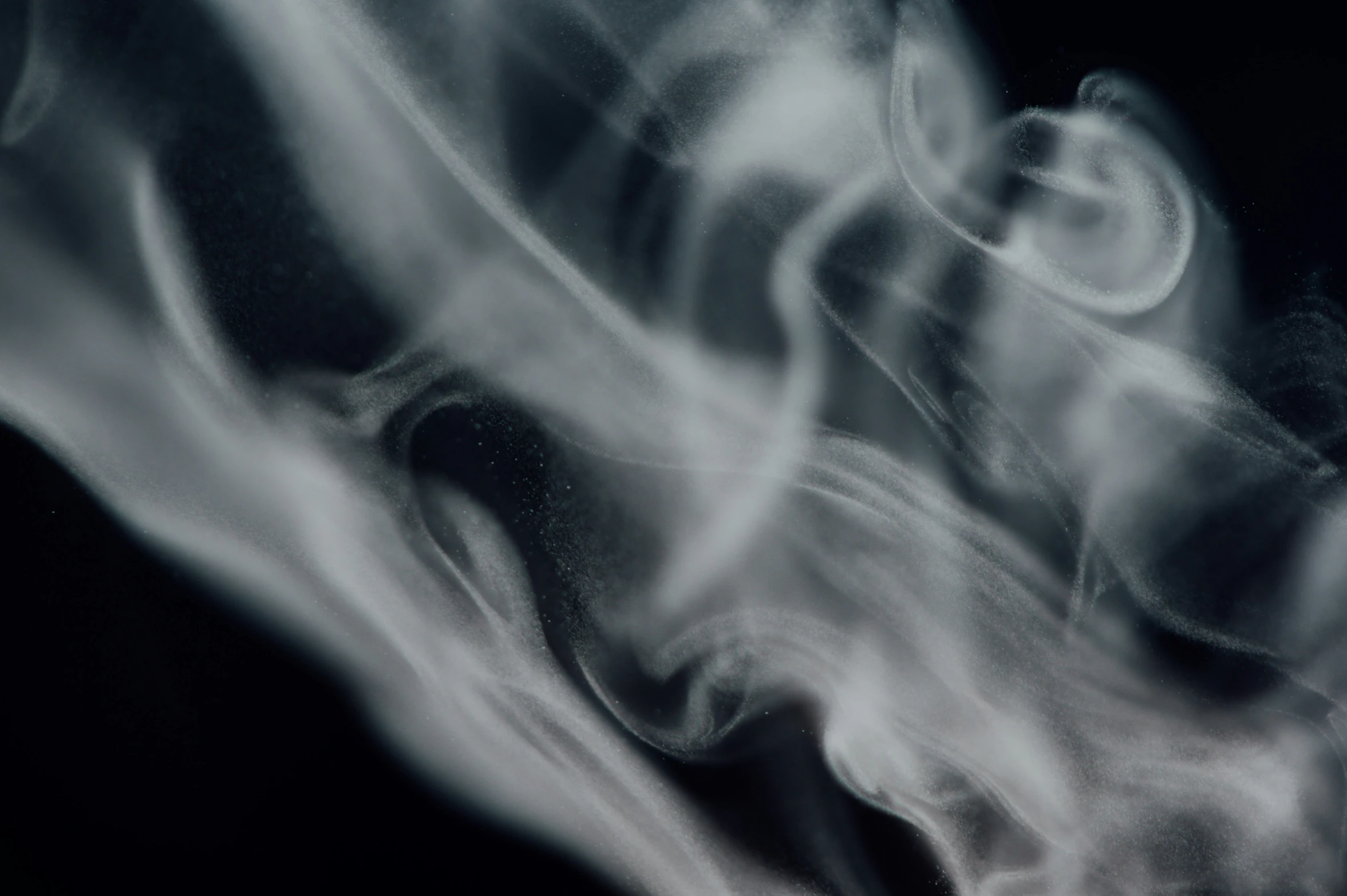 smoke rising up into the air on a black background