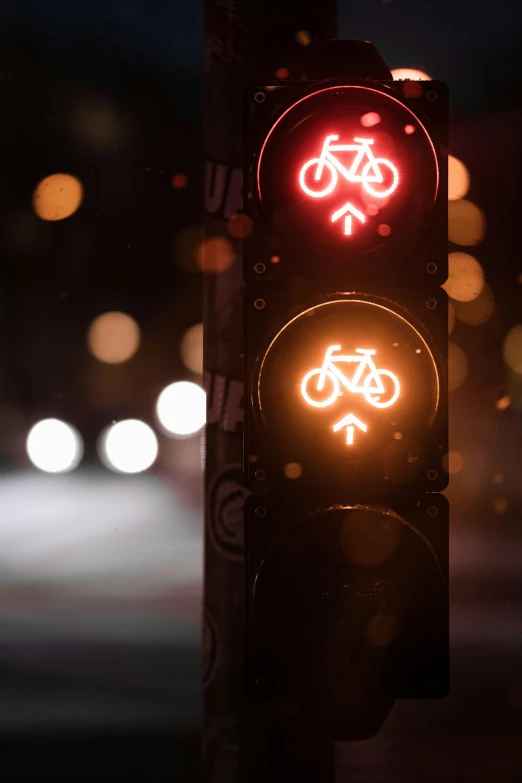 an illuminated traffic light at night in the dark