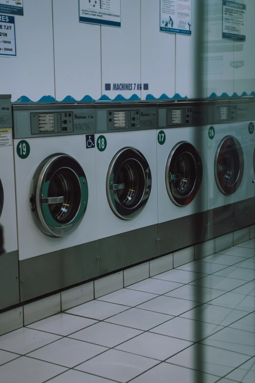 several washers in a public laut next to each other