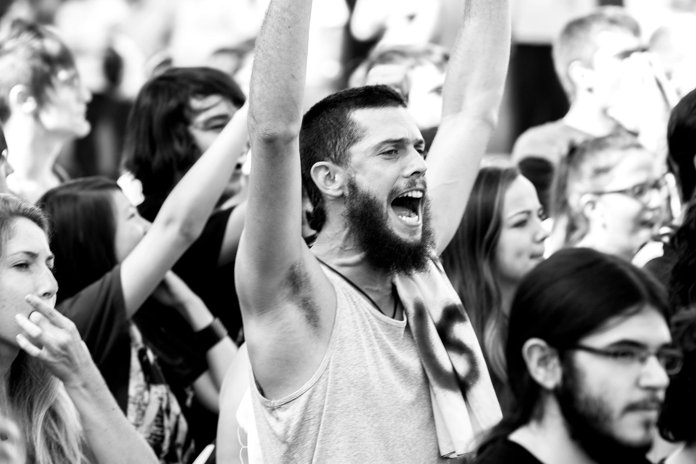 there are many people in the crowd waving and cheering