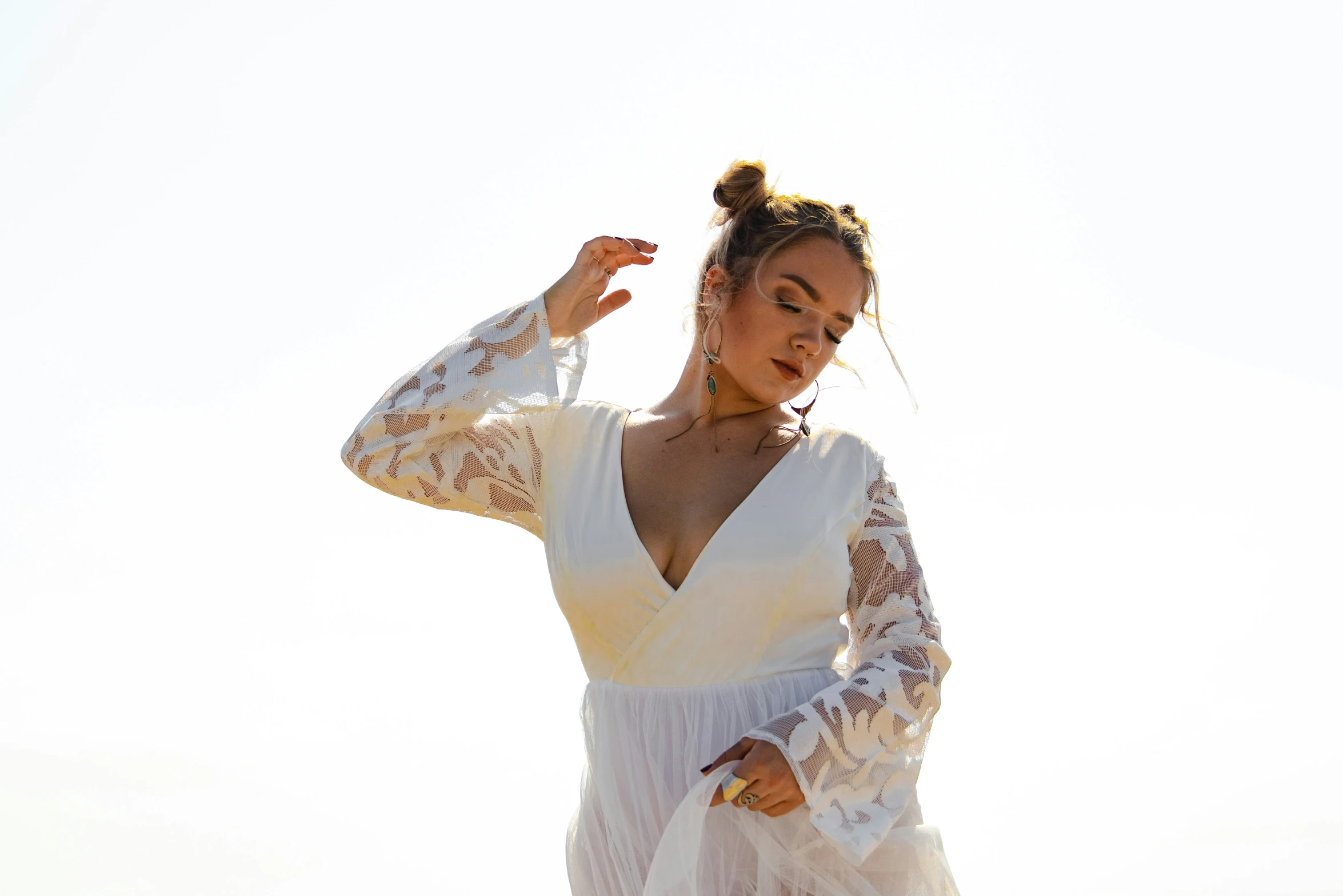 a woman wearing a white gown posing for the camera