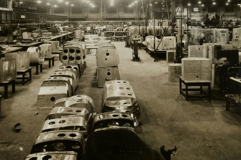 a factory room with cars and people working on assembly line