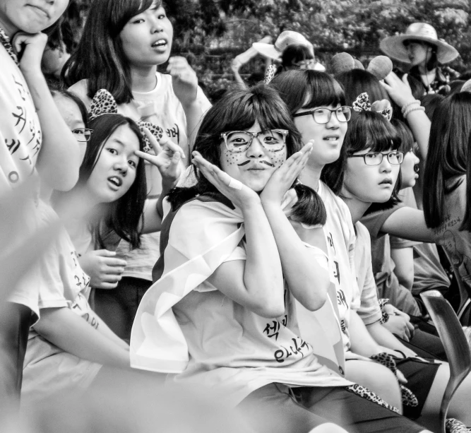 a black and white image of people sitting in the audience