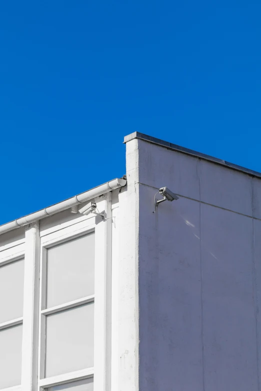 a building with a clock on the side and blue skies