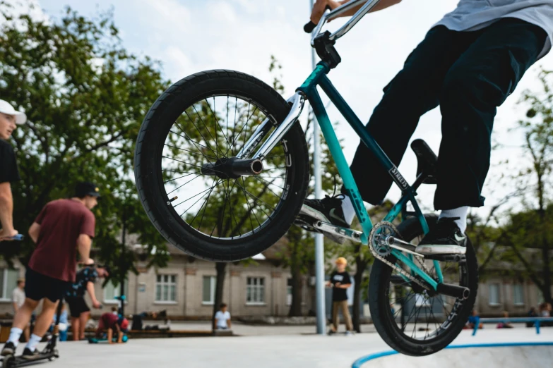  on blue bicycle performing aerial trick