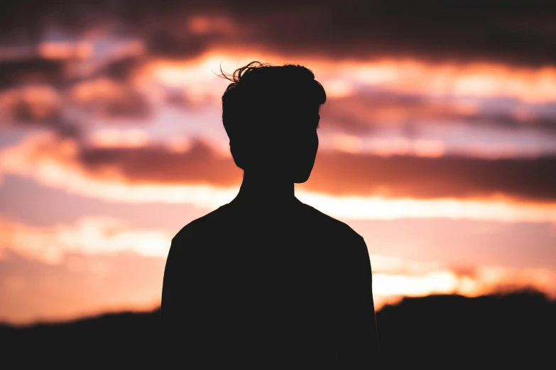 a man is staring at the clouds from his shoulders